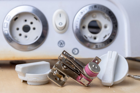Spare parts for the repair of a household oven. A split stove for baking dishes. Light background.の写真素材