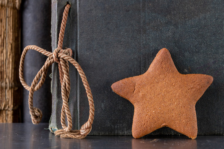 Tasty gingerbread and book loss. Dessert on a wooden table in the cabinet. Light background.の写真素材