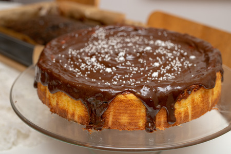 Decorating tasty cakes in the home kitchen. Preparing dessert for the holidays. Light background.の写真素材
