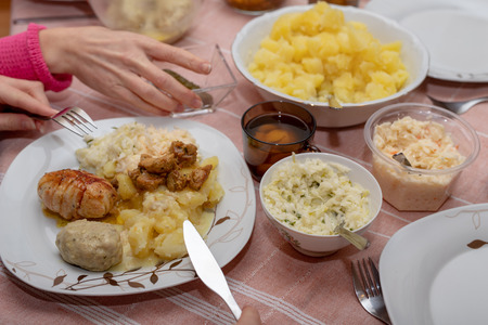 Dishes prepared for a homemade dinner. Family meeting at the kitchen table. Light background.の写真素材