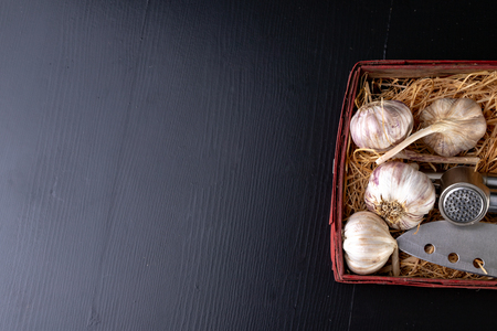 Fresh and healthy garlic on a black kitchen table. A healthy natural antibiotic for colds. Dark background.の写真素材