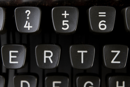 Keys in a typewriter. Symbols of letters and numbers on the keyboard. Light background.の写真素材