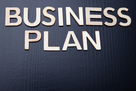 The inscription is arranged from letters cut out of wood on the table. The word â€“ busines...
