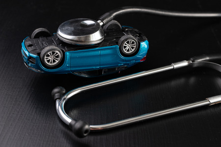 Diagnosis of a passenger car. Repair and troubleshooting in car workshops. Dark background.の写真素材