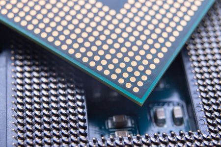 The motherboard and computer components. Computer accessories on a workshop table. Dark background.
