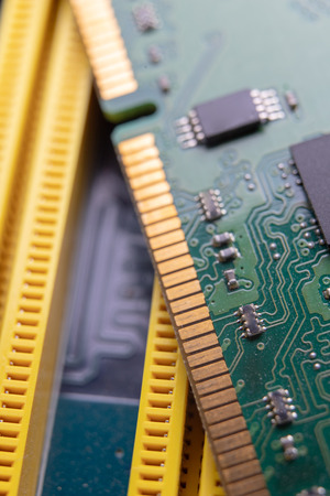 The motherboard and computer components. Computer accessories on a workshop table. Dark background.