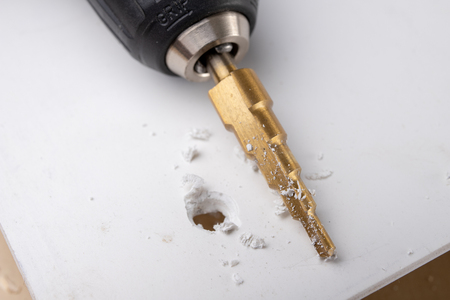 Drill in the shape of a cone for quick drilling. Accessories for mechanics. Light background.の写真素材