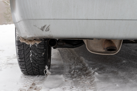 Exhaust pipe of a passenger car. Exhaust system in internal combustion engines. Season winter.の写真素材