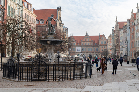 Gdansk, Pomeranian / Poland - February, 07, 2019: Walking people on the market near Neptune. Market square and pedestrian promenade in the city center. Season roklu winter.のeditorial素材