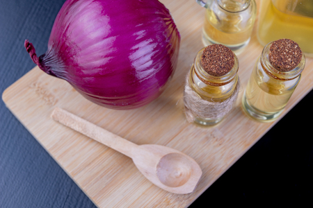 Onions and medicinal juice for colds. Home remedies for colds. Dark background.の写真素材