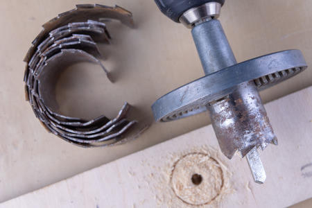 A device for making holes in wood. Joinery accessories for DIY enthusiasts. Dark background.の写真素材