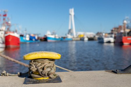 Ship mooring rope moored on the bollard. Moored boat in the port. Winter season.の写真素材