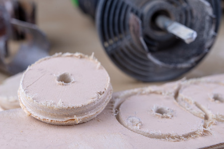 A device for making holes in wood. Joinery accessories for DIY enthusiasts. Dark background.の写真素材