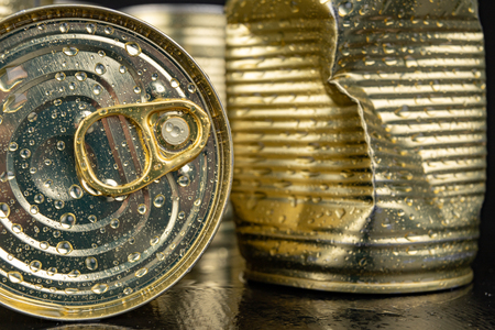 A wet can with vegetables. Drops of water on a metal can lid. Dark background.の写真素材