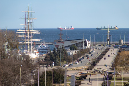 Gdynia, Pomorskie / Poland - February, 26, 2019: Kosciuszko Square and walking people. Harbor quay and ships in a harbor. Season of the spring.のeditorial素材