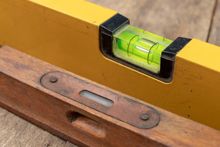 Measuring the slope of a surface using a spirit level. Measuring accessories for mechanics. Dark...