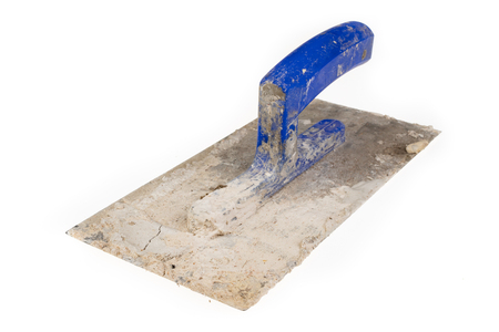 A dirty plastering plaster on a workshop table. Tools for construction workers. White background.の写真素材