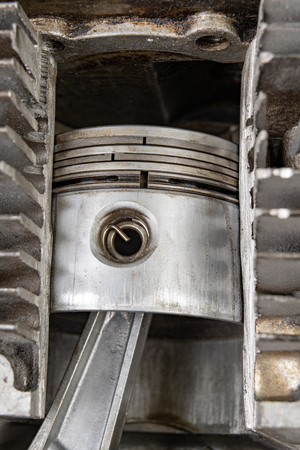 A four-stroke gasoline engine in section. The interior of a single-cylinder internal combustion engine. Dark background.の写真素材