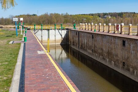 Biala Gora, pomorskie / Poland - April, 16, 2019:. The construction of the hydrological tower. Sluice regulating the water level in the Central Europe. Season of the spring.のeditorial素材