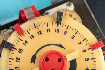 Electrical device for industrial time measurement. An old counter for switching electrical devices. Dark background.の写真素材