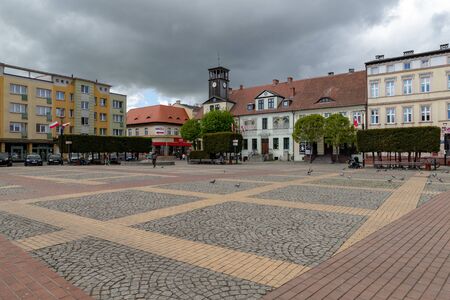 Bialogard, zachodniopomorskie / Poland - May, 7, 2019: The market of a small town in Central Europe. Old tenement houses and buildings in the city. Spring of the year.のeditorial素材