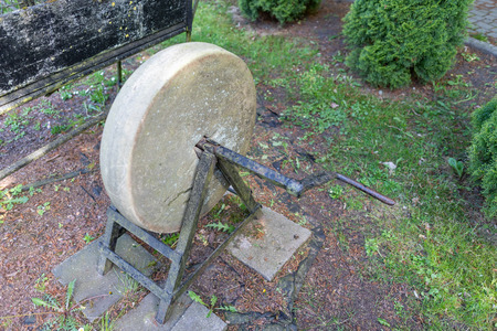 Old wheel for sharpening tools. Exhibit in the open-air museum in Central Europe. Season of the...