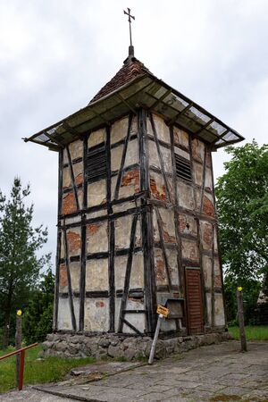 Wierzchowo, zachodniopomorskie / Poland - June 7, 2019: Old belfry from the Prussian wall and church in a small village in Pomerania. Christian temple in Poland. Spring season.のeditorial素材