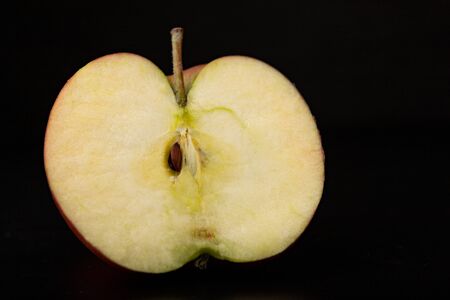 Tasty ripe apple on a dark table. Rich berries prepared to eat. Black background.