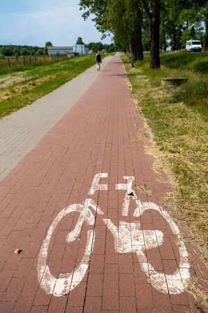 Bicycle path and sign denoting a place for bicycles. A place for active recreation. Season of the...