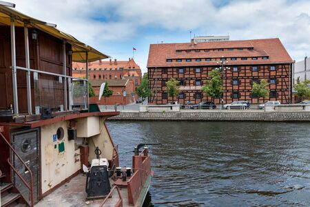 Bydgoszcz, kujawskopomorskie / Poland - June 27, 2019: Beautiful historic buildings on the Brda River. Old tenements and modern buildings on the banks of the river in Central Europe. Season of the summer.のeditorial素材