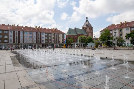 Koszalin, zachodniopomorskie / Poland - June 28, 2019: Town hall and market square with a fountain. Center of the city in Central Europe. Season of the summer.のeditorial素材