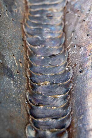 The fillet weld is placed using the MAG method. Errors in steel connections using arc welding. dark...