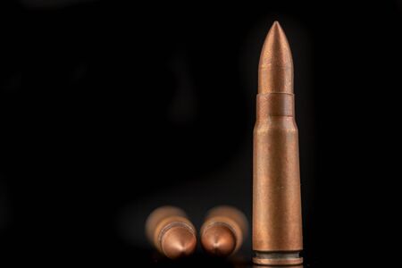 Ammunition of a high-speed rifle. Cartridges for a military rifle. Dark background.