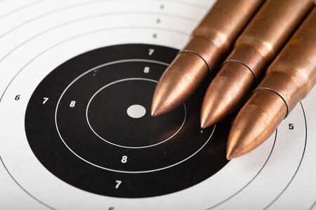 Ammunition rifle ammunition lying on the shield. Cartridges for a military rifle. Dark background.の写真素材