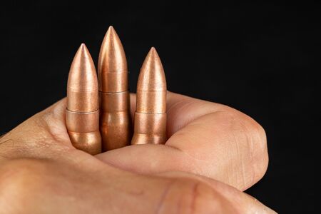 Ammunition of a quick-fire rifle held in the palm of your hand. Cartridges for a military rifle....