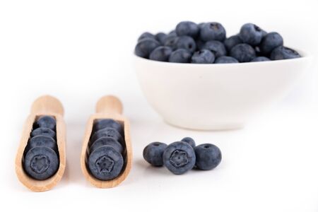Tasty ripe blueberry fruit on the kitchen table. Ingredients for a delicious dessert in the home kitchen. Light background.の写真素材