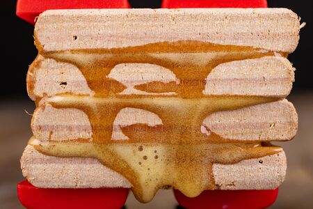 Gluing wood with waterproof adhesive. Pieces of wood pressed together with carpentry clamps. Place -...