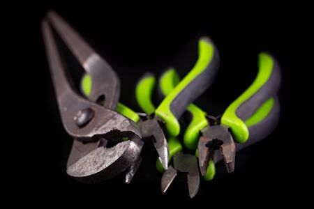Pliers and pliers on a workshop table. Accessories for mechanic and hudraulics. Dark background.の写真素材