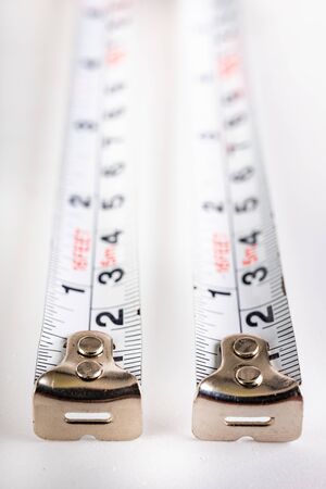 Metal joinery measures on a white table. Accessories for production workers. White background.