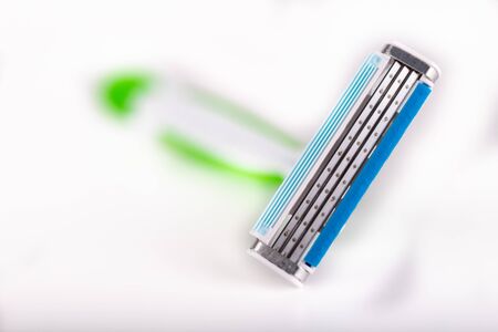 Male razor on a white table. Personal hygiene accessories. Light background.