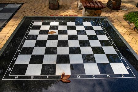 A small chess table in the park. Empty board game table. Summer season.の写真素材