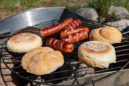 Tasty sausages prepared on the grill. A tasty meal outdoors in the home garden. Summer season.の写真素材