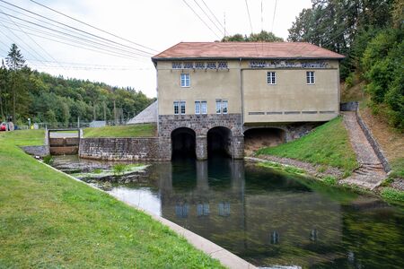 Rutki, pomorskie / Poland - September, 5, 2019: Hydroelectric power plant on the Radunia river. A building for obtaining free energy from nature. Summer season.のeditorial素材