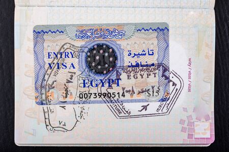 Visa to Egypt in the passport. Documents needed to cross the border. Dark background.の写真素材