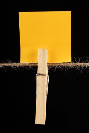 Wooden buckles hung on a clothesline and colored cards. Place on the cards for text messages. Dark background.の写真素材