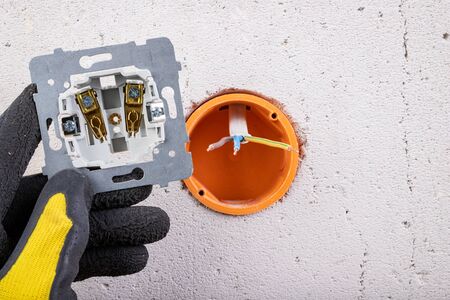 Installation of the electric socket in a rough wall. Installation of a new electrical network at...