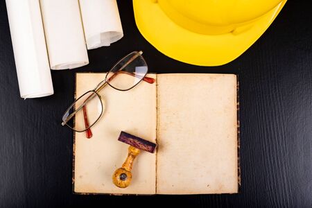 Helmet and design documentation. Accessories for an engineer on a construction site. Dark...