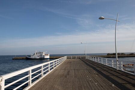 Puck, Pomorskie / Poland - October, 25, 2019: Pier on the bay in Central Europe. Wooden bridge with a restaurant for tourists. Autumn season.のeditorial素材
