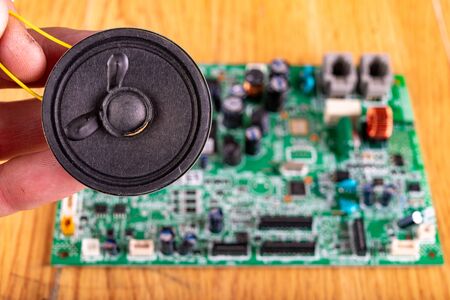 Old speaker removed from the radio. Electronics from old electronic devices. Dark background.の写真素材