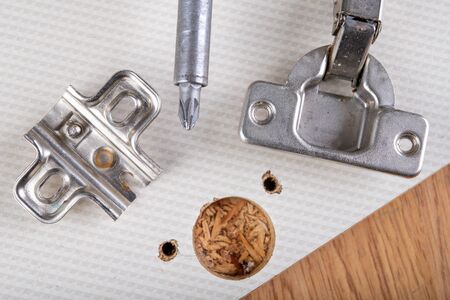 Installation of furniture hinges in the kitchen cabinet door. Tools and furniture accessories needed...